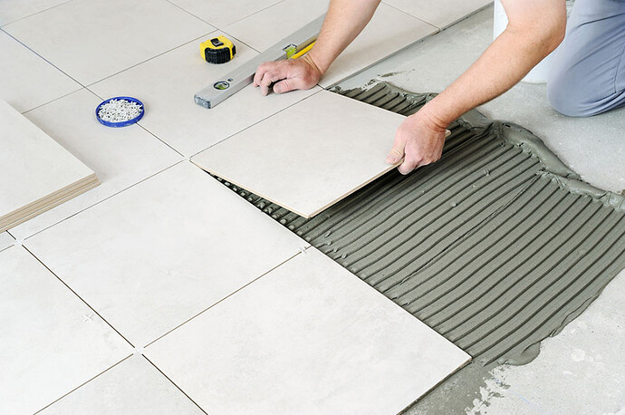 laying ceramic tile on the floor
